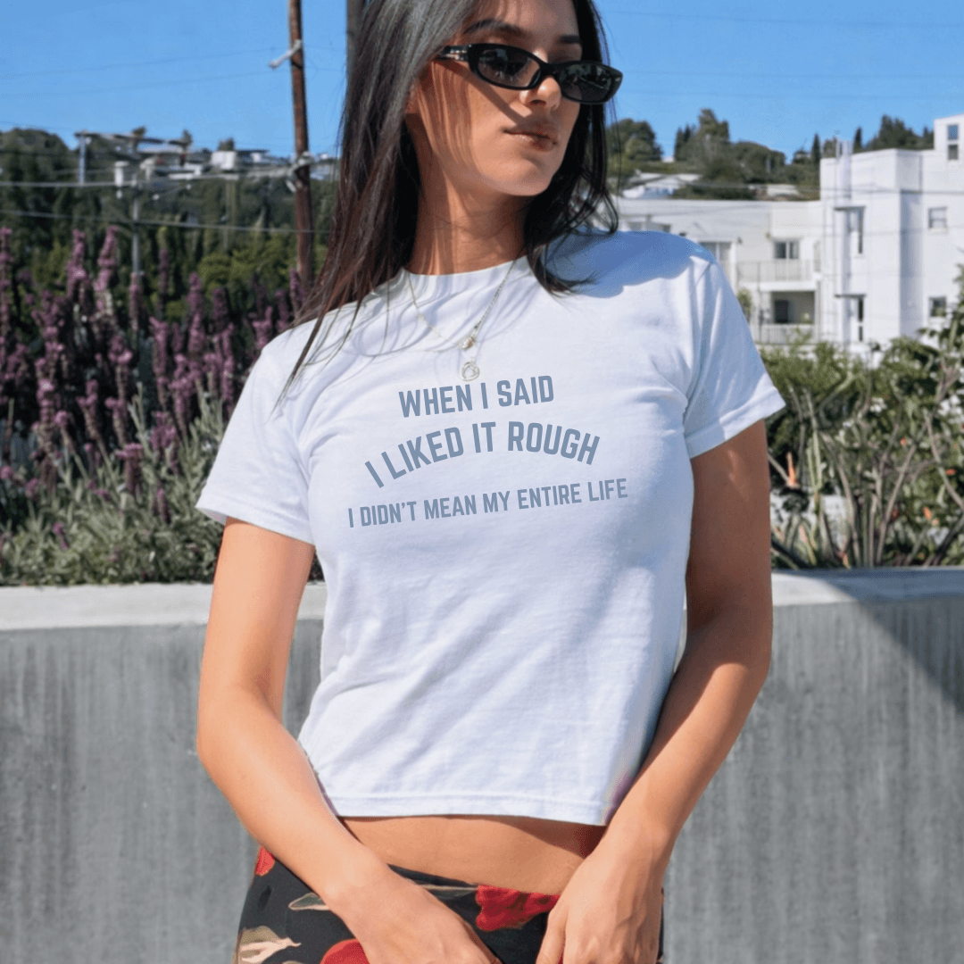 Woman wearing a white t-shirt with text outdoors